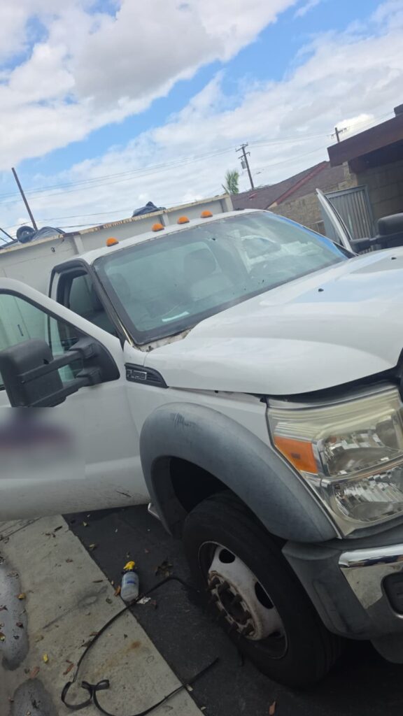 Ford F-450 work truck with a cracked, damaged windshield before replacement by Reyes Glass Group