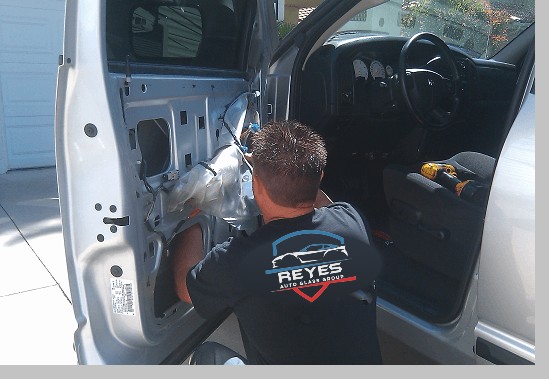 Technician repairing door and vent glass